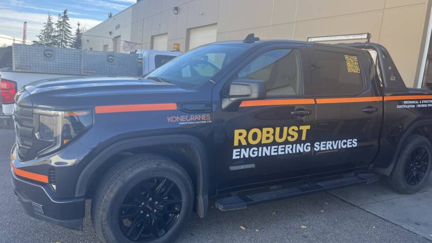 Black GMC Sierra crew cab wrapped in Robust Engineering Services orange-and-black branding, with a Konecranes Preferred Contractor badge and a roof-mounted LED light bar